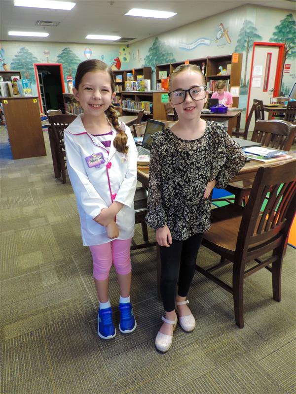 students in the library smiling